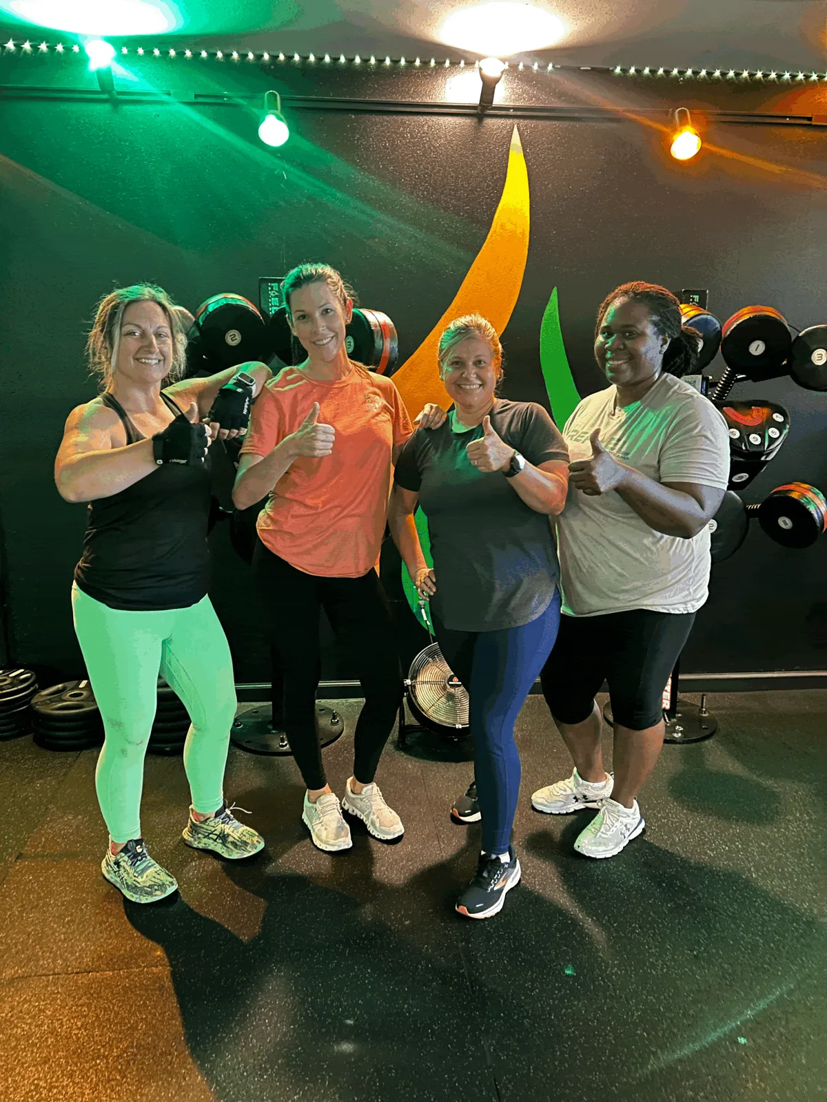 ReFuel Bootcamp members posing in front of the studio mural